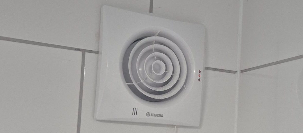 Electrician rewiring a house with green electrical cable exposed