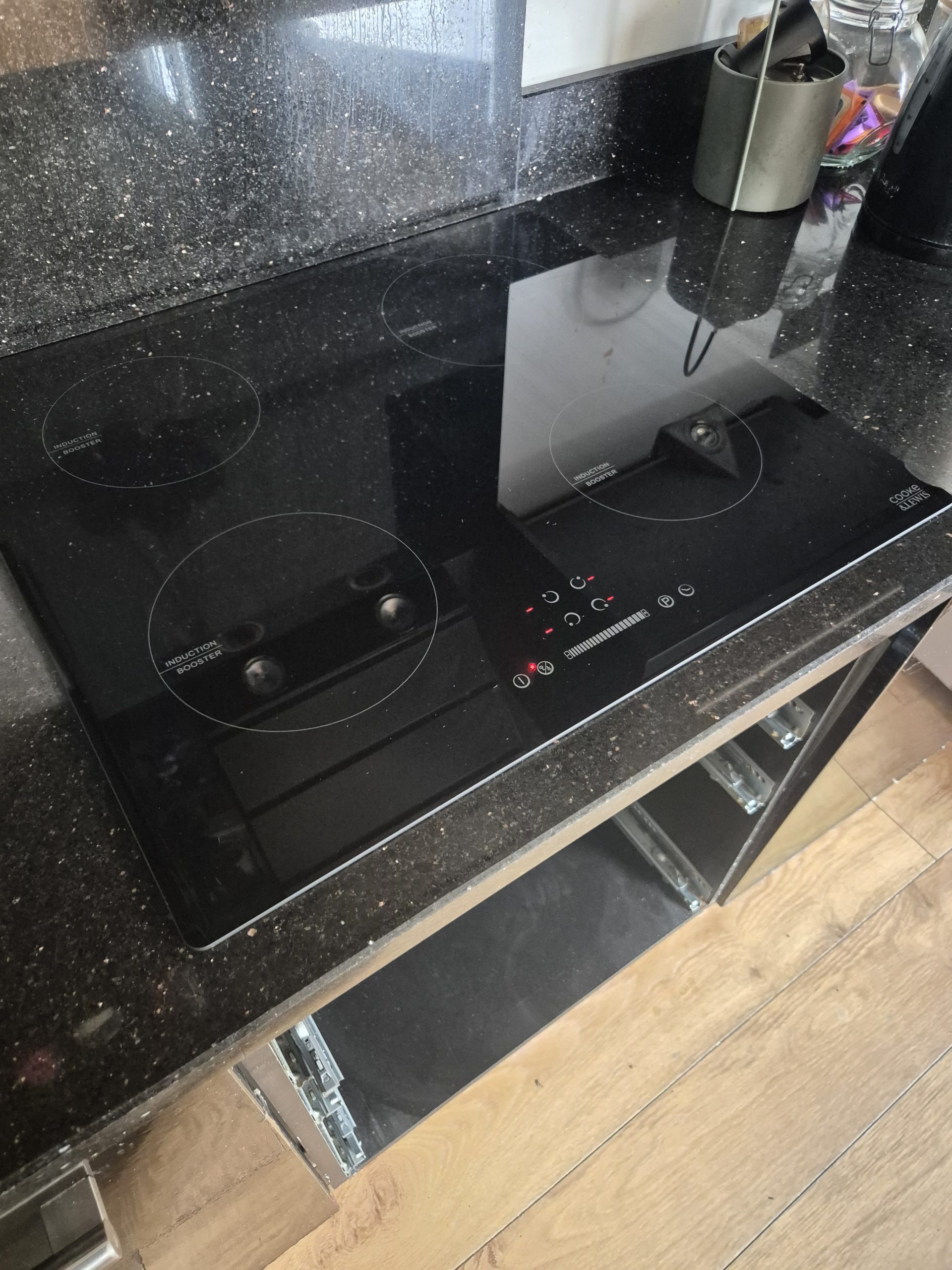 Electrician rewiring a house with green electrical cable exposed